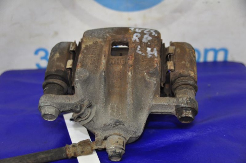 Суппорт тормозной задний левый TUCSON 04-10