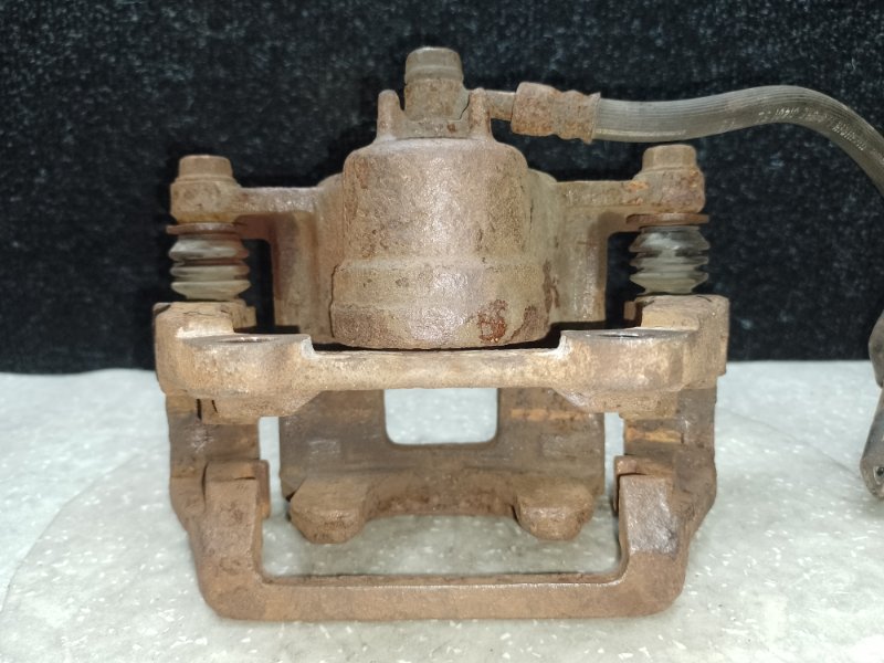 Суппорт тормозной задний левый MDX (YD2) 06-13