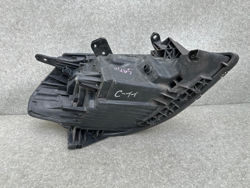 Фара левая TIIDA/VERSA C11 04-11