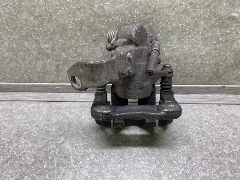 Суппорт тормозной задний левый CIVIC 4D 06-11