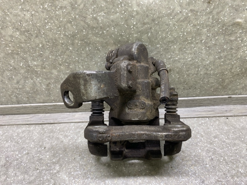 Суппорт тормозной задний левый CIVIC 4D 06-11